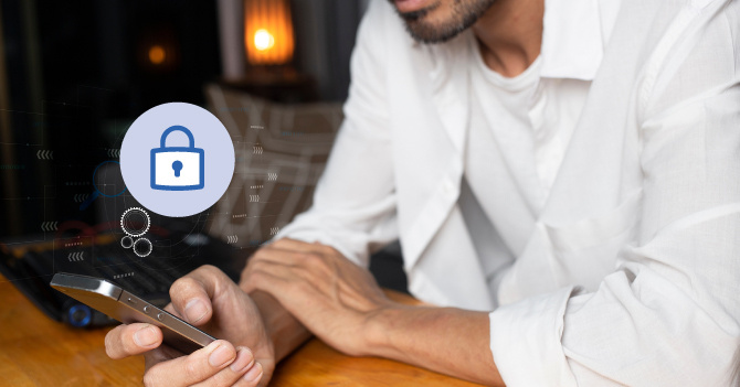 Man holding a smartphone with a security lock icon.