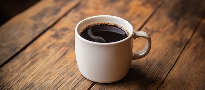 A black coffee on a table.