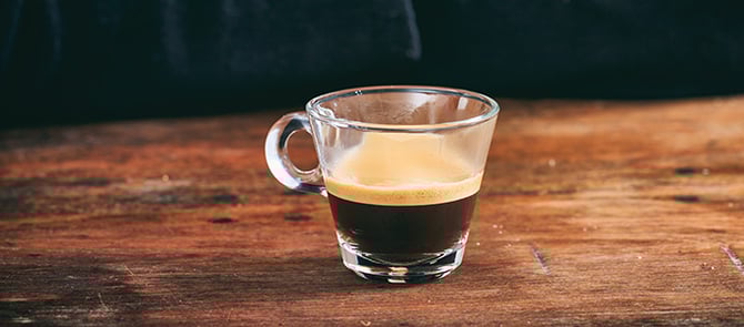 A espresso shot on a table.