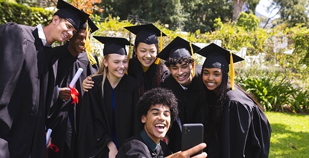 A group of college kids celebrate at their graduation.