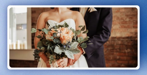 A married couple holding flowers.