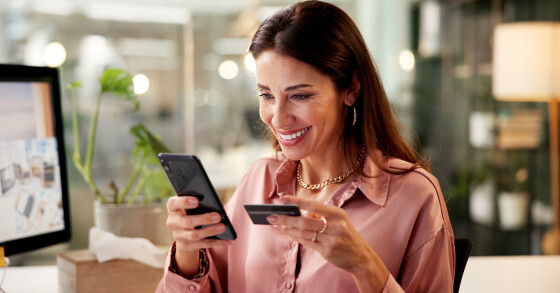 Woman entering her card information into her smartphone